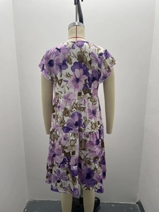 Detail view of the purple floral print tiered skirt and back design on a casual dress