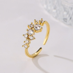 Macro shot of 18K gold plated ring with sparkling zircons on elegant white background