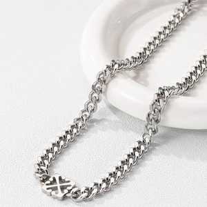 Polished titanium steel Cuban chain necklace featuring a vintage cross pendant on ceramic