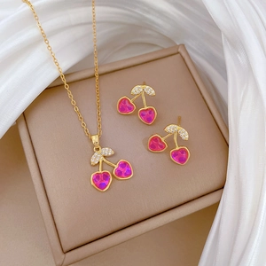 Titanium steel cherry jewelry set with pink heart stones and diamonds on silk