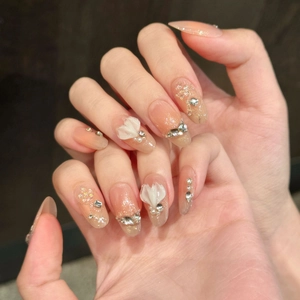 Almond press-on nails with 3D floral carving and champagne blush cat-eye gradient effect