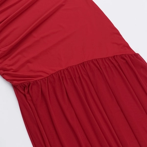 Detailed close-up of red ruched fabric showing elegant texture and stitching for women's dress