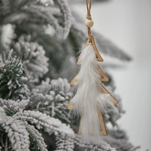 Plush wool and wooden Christmas tree ornament hanging on a snowy pine branch