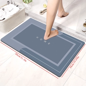 Detail showing the 80x50cm grey diatom mud bath mat with HOME text and non-slip texture