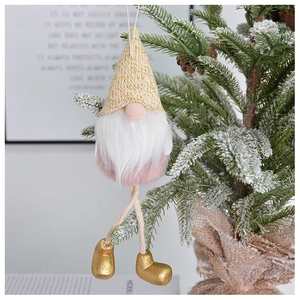 Pink velvet Christmas gnome ornament with long beard hanging on a green tree branch