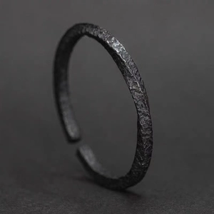 Minimalist black Mobius ring with unique hammered texture and open adjustable design