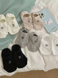 Close-up of five pairs of cotton low-cut boat socks with delicate bow details