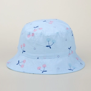 Close-up of light blue kids bucket hat featuring pink cherry and white heart patterns