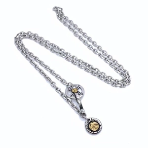 Detail view of titanium steel feather pendant necklace with gold accents and clasp