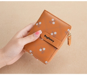 Close-up of brown PU leather wallet with floral pattern and snap button closure