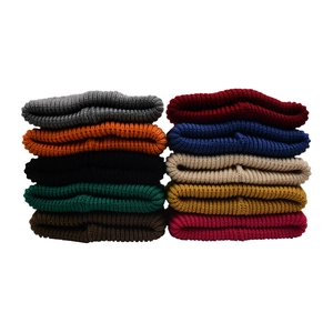 Close-up of ribbed knit beanies in 10 diverse colors showing thick elastic texture