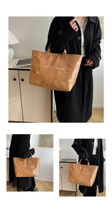 Close-up of brown textured tote bag with white TOTE BAG printing and glossy finish