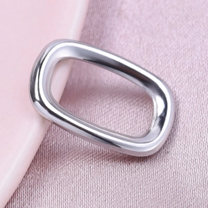 Macro shot of polished 304 stainless steel square hollow pendant on pink silk