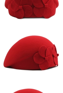 Detailed view of red wool beret with handcrafted flower petal decoration on the side
