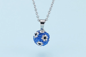 Close-up of blue and white crystal pavé ball pendant on a silver-tone chain necklace