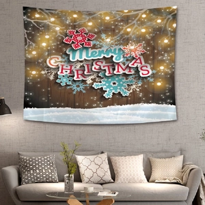 Christmas tapestry with Merry Christmas text and snowflakes hanging in a cozy living room