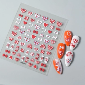 Detail of red and white 5D embossed heart and bow nail stickers for DIY manicure