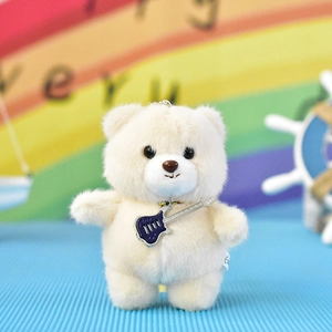 Adorable plush bear keychain featuring a miniature guitar accessory and soft cream fur.