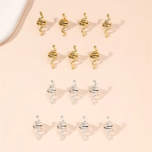 Detail view of 15-piece set snake-shaped spiral hair rings in gold and silver metal finishes