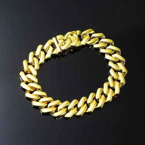 Polished gold Cuban link chain bracelet for men with secure clasp on black background