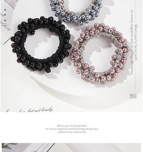 Detailed view of high-elastic beaded hair ties in black, grey, and rose pink colors