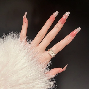 Detail of gold plated square watch style ring with cubic zirconia on a model hand