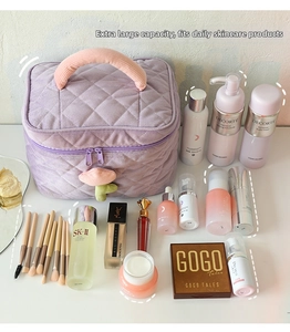 Purple corduroy cosmetic bag with floral zipper showing high capacity for toiletries