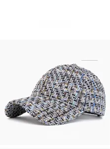 Detail of blue tweed baseball cap featuring multi-color woven texture and gold thread