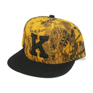 Yellow flat brim baseball cap with black letter K embroidery and graffiti print