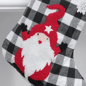 Christmas stocking with black and white plaid pattern and embroidered Santa Claus design