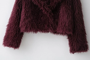 Detail of burgundy long-hair faux fur jacket showing soft texture and premium plush fibers