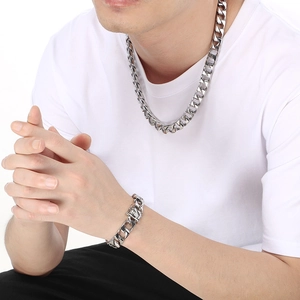 Silver stainless steel Cuban link chain necklace and bracelet set worn by male model