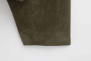 Detail of dark olive green faux suede jacket featuring refined stitching and smooth texture