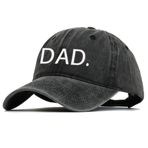 Close-up of DAD embroidery on washed black cotton baseball cap with curved brim