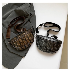 Close-up of printed fanny packs with skull patterns, metallic finish and chain detail