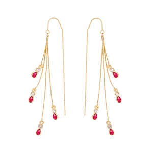Detailed view of long gold tassel earrings with red teardrop gems and clear crystals