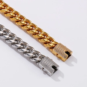 Macro view of 12mm gold and silver Cuban link chains with CNC iced out diamond clasps
