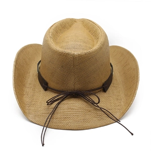 Close-up of woven straw cowboy hat with brown leather band and decorative string bow