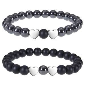 Macro shot of tiger eye and obsidian beaded heart bracelets with contrasting matte and glossy beads