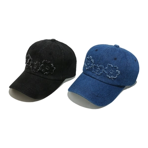 Top view of denim baseball caps with vintage raw-edge floral embroidery details