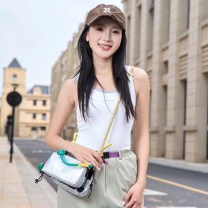 Modern silver outdoor crossbody bag shown with sporty outfit in an urban setting