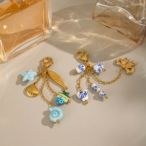 Porte-clés doré thème océan avec breloques étoile de mer et perles en céramique bleue