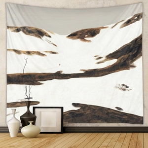 Artistic mountain landscape tapestry displayed on a grey wall in a modern living room