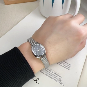 Detail of Naidu vintage oval watch with silver metal band on a feminine wrist