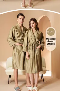 Detail view of mustard green ribbed bathrobe with contrasting white piping and large pocket