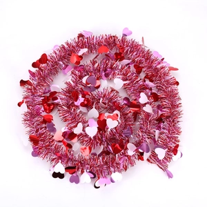 Top view of spiral Valentine's tinsel garland with red and pink heart-shaped sequins