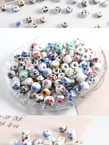 Close-up of assorted ceramic beads with floral patterns in a glass dish for DIY jewelry