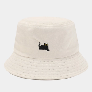 Close-up of cute black cat embroidery on a beige cotton bucket hat with parallel stitching