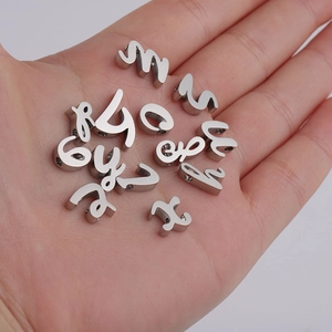 Close-up of polished stainless steel number beads for DIY jewelry making in palm