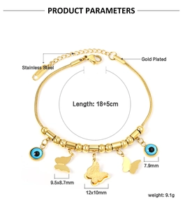 Detail of gold plated stainless steel bracelet with evil eye and butterfly charms